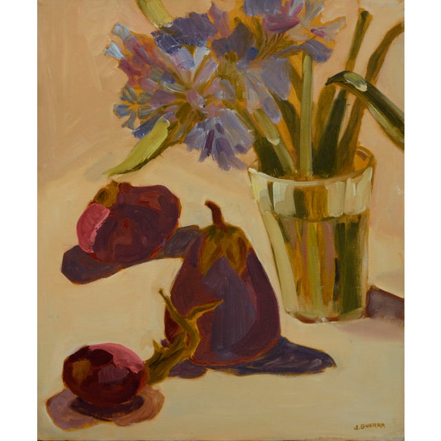 Beautiful botanical still-life of a large purple pear and a glass full of cut flowers with a background of soft, warm...