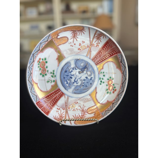 A finely decorated Japanese Imari porcelain plate dating to the Meiji period (late 19th century), featuring a central...