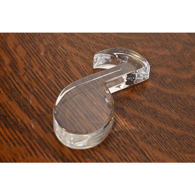 A gorgeous crystal glass musical note paper weight By Tiffany and Co. USA, Late 20th Century Measures: 3"W x 4.13"D x...