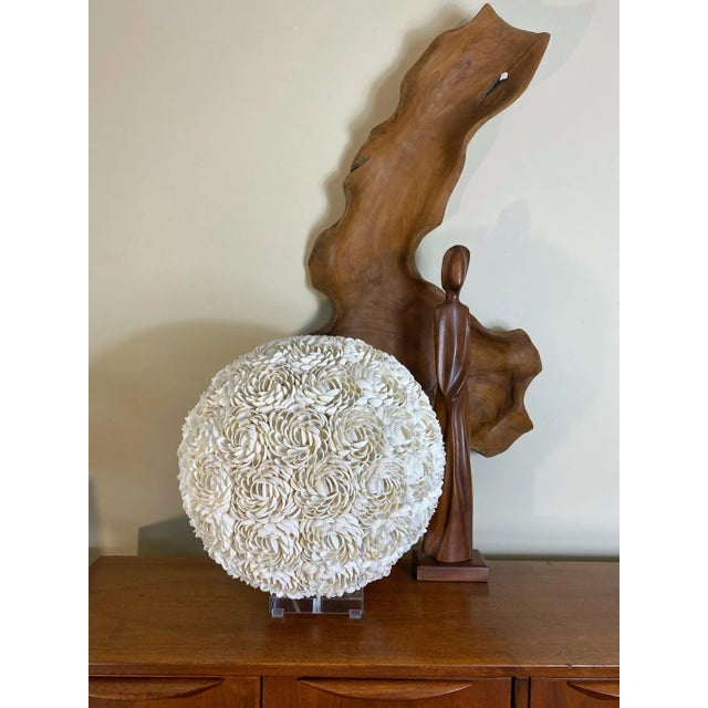 Designed and assembled by Junk is the new black. Thousands of shells make up this 18” orb. Its beautiful on its own, but...