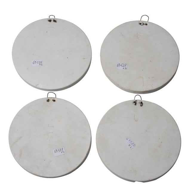 Neoclassical Medals are beautiful decorative objects. Four circular plates in the precious biscuit porcelain with...