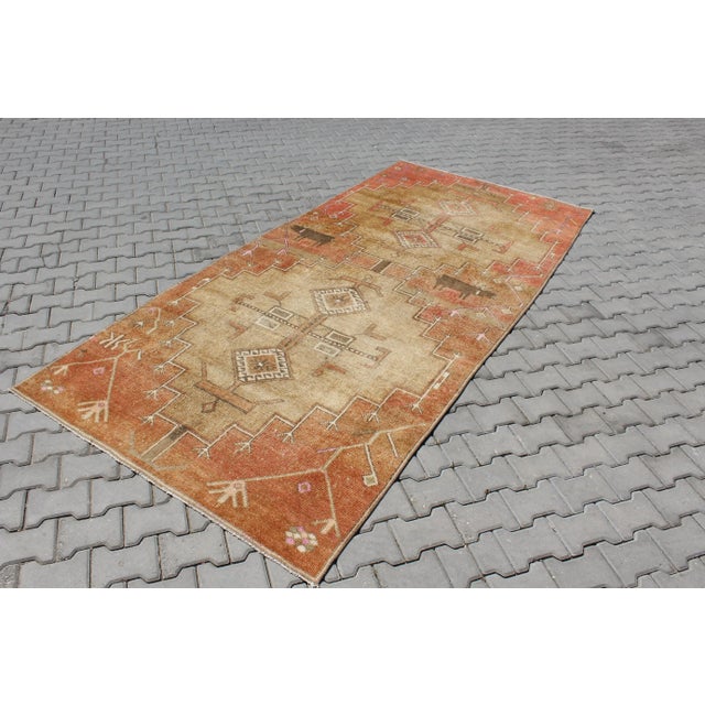 This beautiful, traditional vintage, hand knotted Turkish area rug is approximately 60 years old. It is handmade of very...