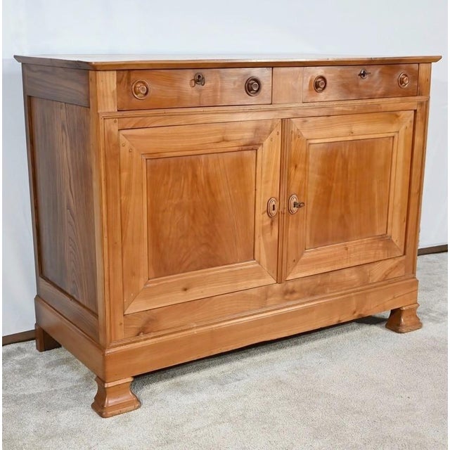 This solid cherry buffet, from the North Nantes region, has two belt drawers with bowl buttons and original functional...