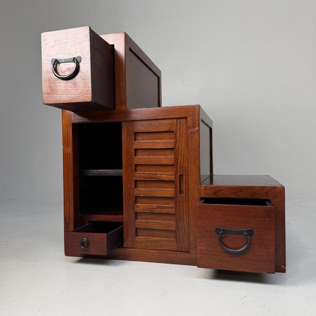 Distinctive Japanese stair chest (kaidan tansu) with a clean geometric silhouette and a warm wood tone beautifully...