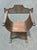 A striking Renaissance Revival Savonarola style chair crafted in carved walnut with a rich dark finish. The sculptural...