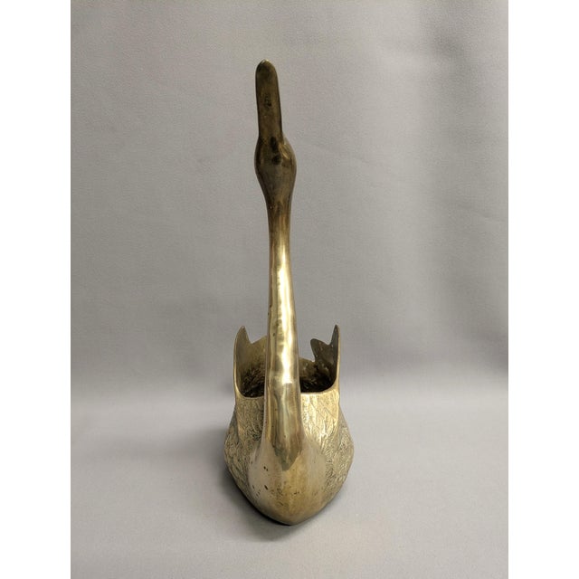 A large brass swan planter from the 1970s, made in Korea. This vintage swan planter is cast in solid brass and displays a...