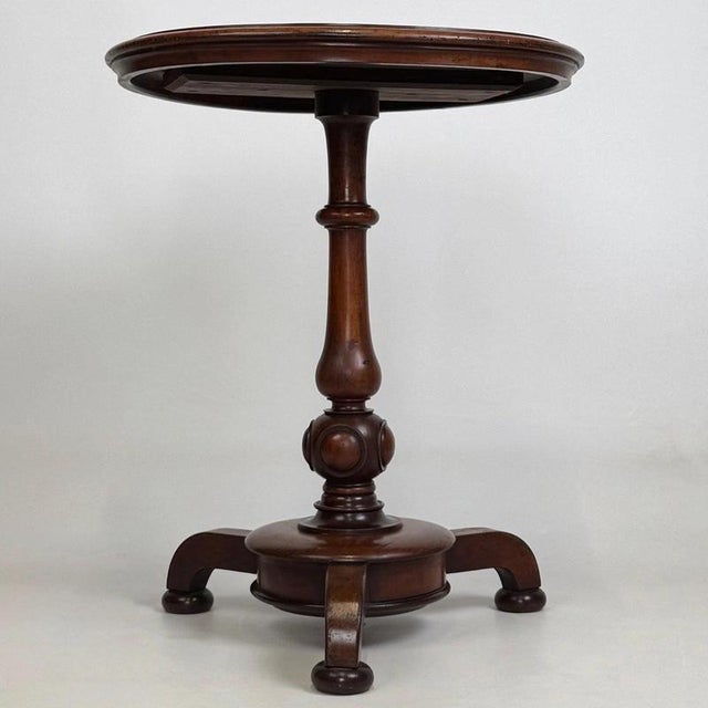 A handsome and elegantly proportioned 19th-century English Victorian side table, beautifully crafted from mahogany and...