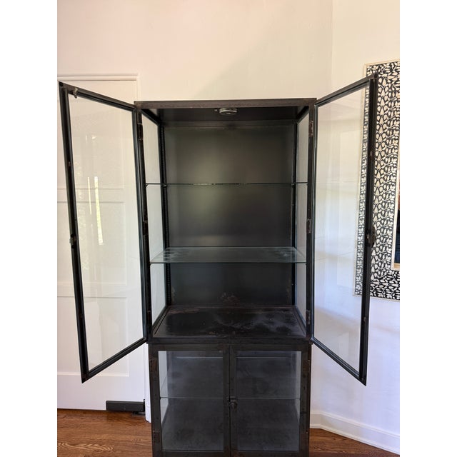 Industrial black iron and glass display cabinet. This is a unique piece for displaying china, dish ware, pottery, books,...