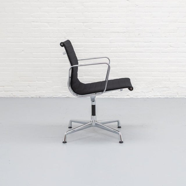 Eames EA 108 swivel chair, upholstered in black Hopsak with a polished aluminium/chrome base & armrests. Designed in 1958...