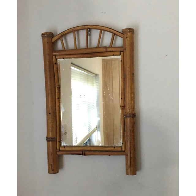1970s bamboo wall mirror with a circular top. No maker's mark.