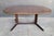 A rosewood Danish Modern expanding dining table. Circa. 1960. Table is unmarked, but attributed to Niels Otto Moller for...
