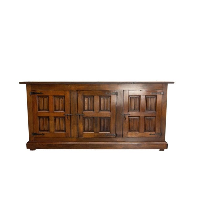 Large Spanish credenza sideboard dresser buffet, made circa 1960 The three doors of this sideboard are carved with motifs...