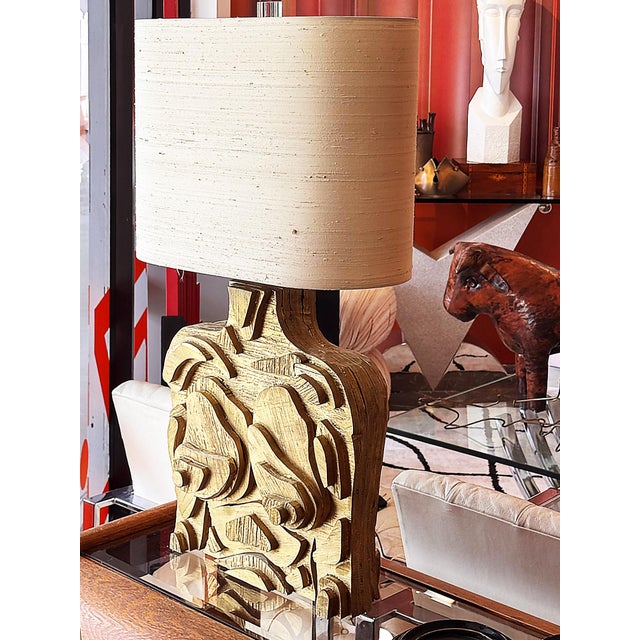 A true conversation piece, this sculptural table lamp features a hand-made wooden base of layered wooden pieces in bold,...