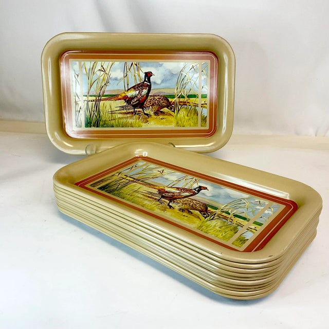 This is a set of 11 Metal Serving Trays from the 1950s. They feature a transferware rustic outdoor scene of two Pheasants....