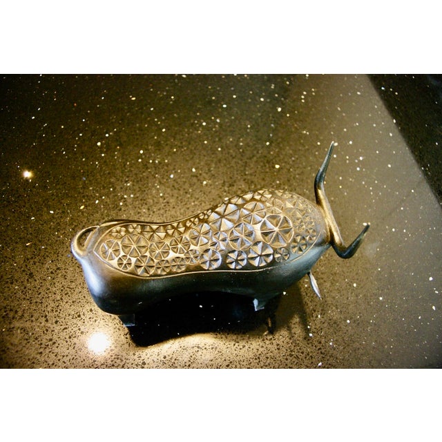 A bull expressing strength and nobility, reduced to essential lines, creating a figure that is both dynamic and...