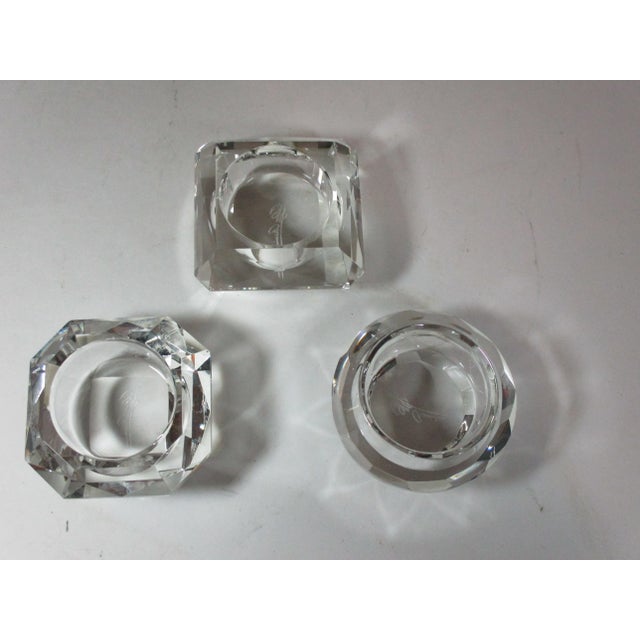 Set of three crystal votives, round, square and octagon shaped, signed Oleg Cassini, in their original black box. These...