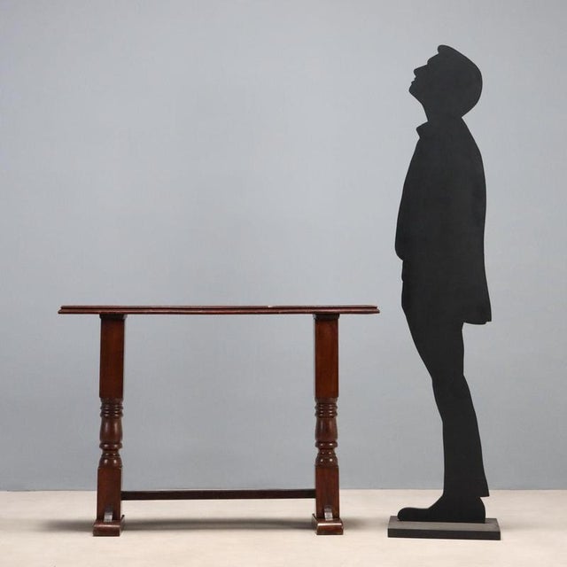 Console table in walnut-stained oak and walnut. Antique top supported by later, square-section, turned legs, joined to the...