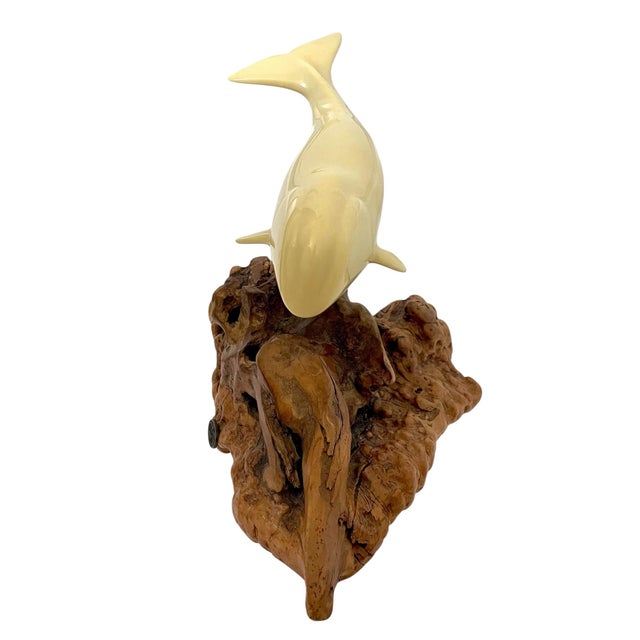 The Vintage John Perry Polar Bowhead Whale Sculpture on Burl Wood is a beautifully crafted figurine made from high-quality...