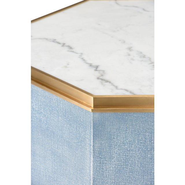 Fabulous octagonal cocktail table wrapped in blue grass linen/canvas and banded with antique brass. This table works alone...