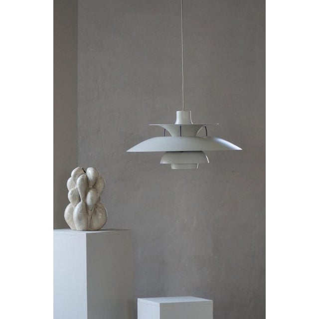 The iconic ph 5 pendant lamp was designed by poul henningsen and introduced in 1958 as part of his lifelong pursuit of...