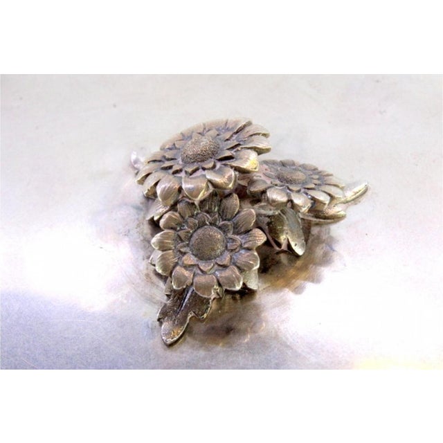 Silver Bonbonniere with Embossed Friezes, 3-Flower Knob Lid and Feet with Palms, in Very Good conditions. Designed from...