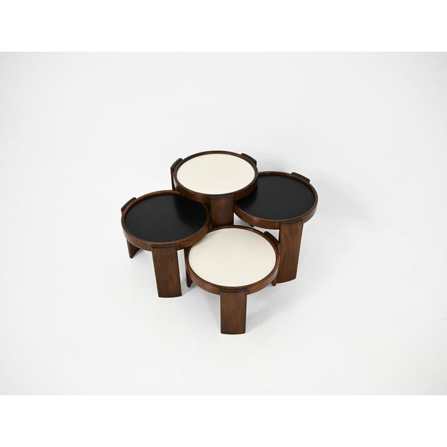Wooden nesting table. Reversible black and white top. Stamped Cassina. Wear due to time and age of the table. Measures:...