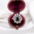 Vintage daisy ring in 18 carat gold (750 thousandths). It is decorated with a central oval sapphire of approximately 1.5...