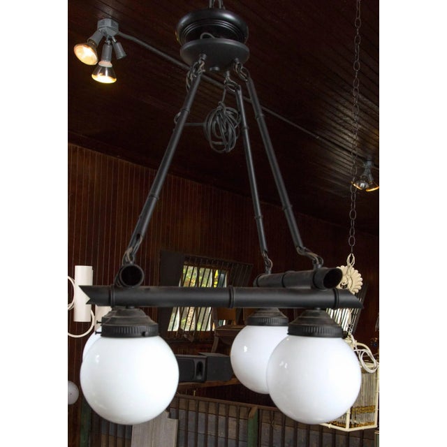 Very stylish and unusual chinoiserie, black metal faux bamboo chandelier. Square horizontal faux bamboo framework with...