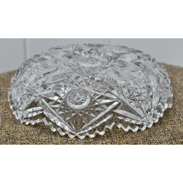 Vintage (1950's) Round Cut Glass Bowl has a Traditional Style . Heavy Brillant Cut Glass. The Measurements: 7"Round x 2"H...