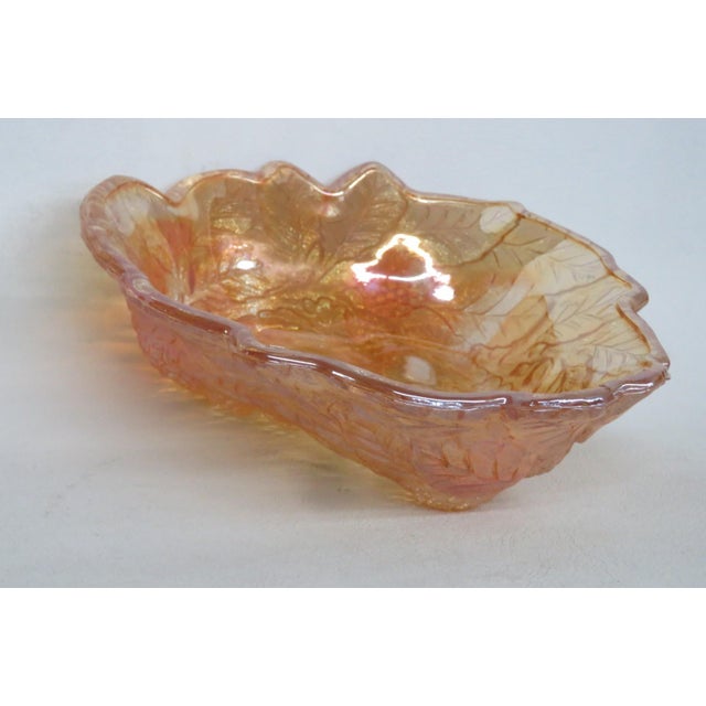 This wonderful Bowl is made of carnival glass. This dish presents a lovely "Leaf and Loganberry" pattern; It features a...