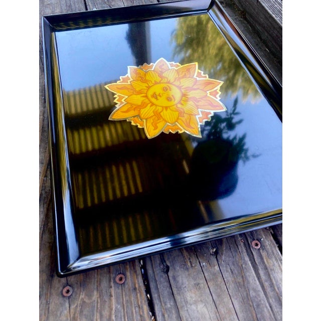 Vintage Couroc of Monterey serving tray featuring a radiant stylized sun face motif rendered in warm golden and amber-...