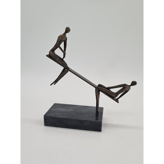 A unique vintage sculpture with a modernist character, depicting two stylised, slender human figures in a dynamic scene of...