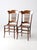 This pair of antique American Victorian spindle back chairs features shaped crest rails, turned front legs and stretchers,...