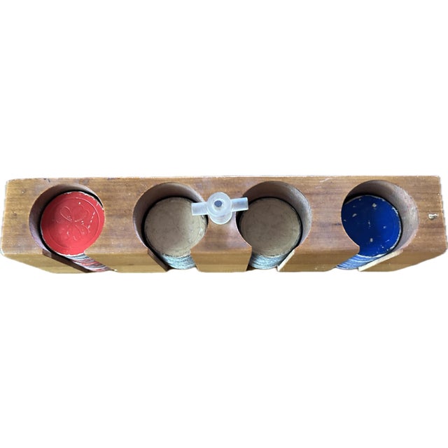 Rare hard to find unique walnut poker chip set with 4 rows of chips. Chips are made of painted cardboard. Lots of wear on...
