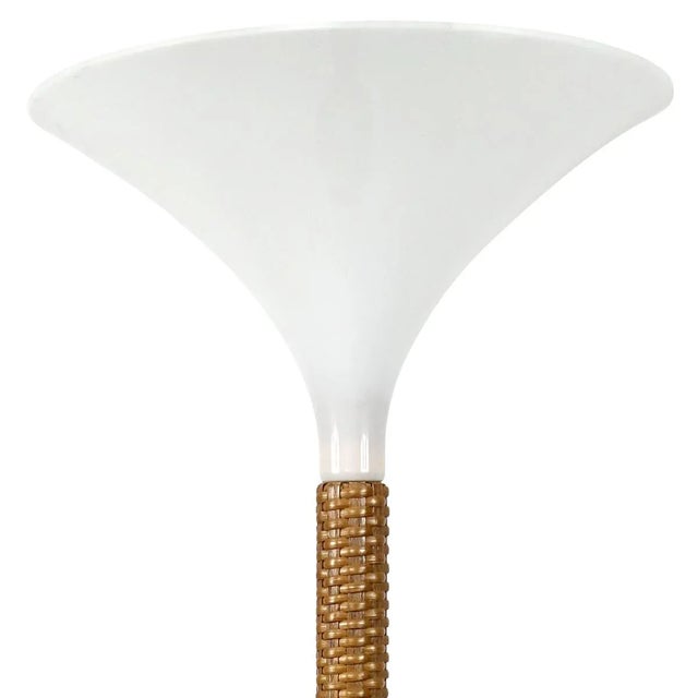 Stunning uplighter made of a braided rattan base that is topped by an upside down "witch hat" shade. European Plug (up to...