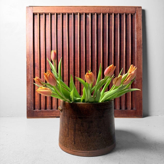 This antique Japanese door panel, originally part of a piece of furniture, has a distinctly architectural presence. The...