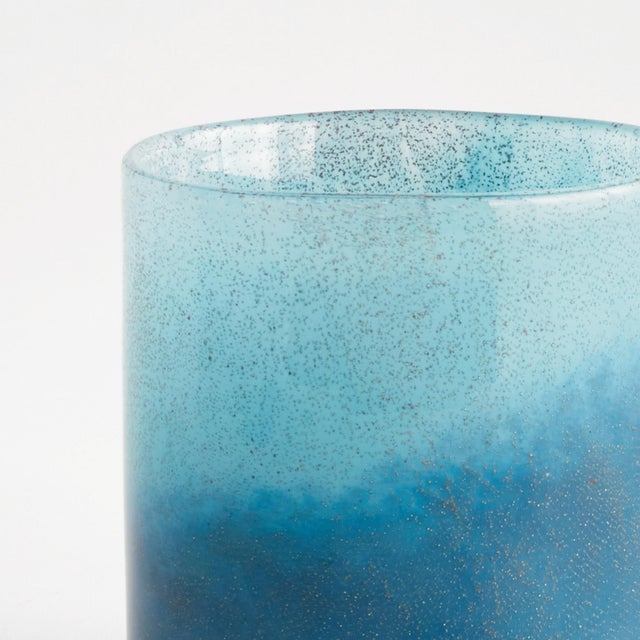 A modern update to the simple glass vessel, the Del Mar Glass Hurricane is made of vibrant shades of blue. The color is...