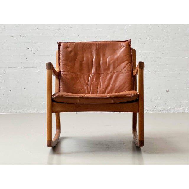 This distinctive lounge chair from france & son embodies the warm, organic design language of danish mid-century modernism...