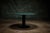 Gubi round table featuring a green marble top and a black metal pedestal base, ideal for dining or accent use. - The...