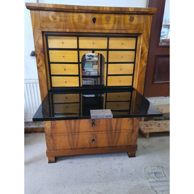 Masterful craftsmanship in a beautiful walnut-grain veneered headboard, below which is a large drawer; a very beautiful...
