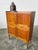 : Tall sideboard made of solid teak wood, featuring four doors with various shelves, and two separate drawers, one of...