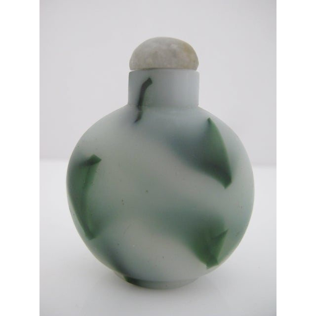 Vintage Beijing glass snuff bottle featuring colorful green striations on a frosted white background. Stopper with intact...