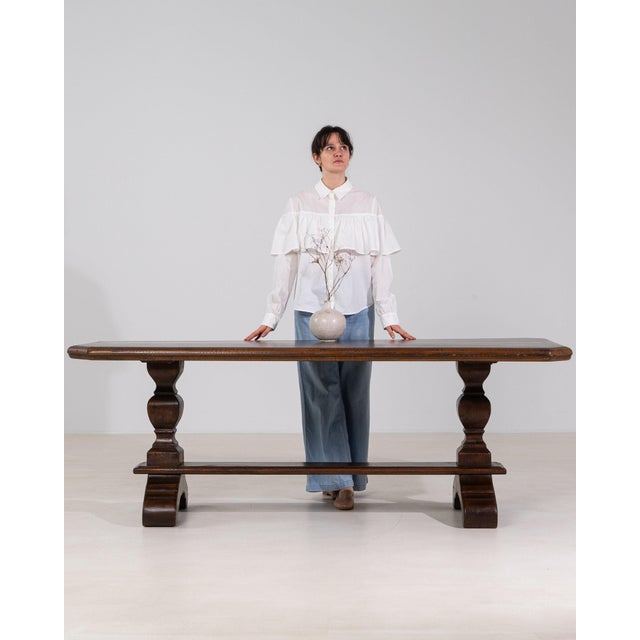 This console table makes its impression through dark mahogany, stepped scroll form. It was made in France during 20th...