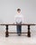 This console table makes its impression through dark mahogany, stepped scroll form. It was made in France during 20th...