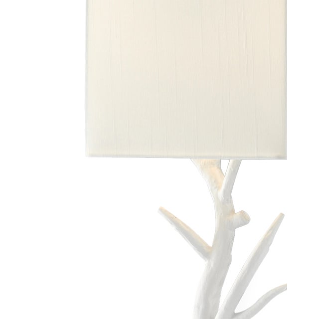 The Baneberry Wall Sconce, Right, is made of wrought iron in a Gesso white finish with flowing stems reaching through the...