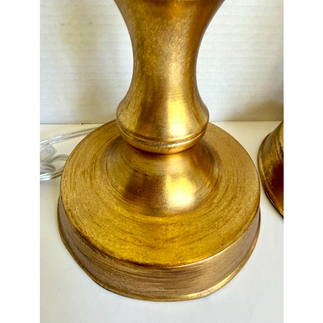 Here is a stylish pair of contemporary faux bamboo table lamps with a warm brushed gold finish. The tall, slender bases...