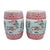 A vibrant pair of famille rose porcelain garden stools, decorated with traditional figural and botanical scenes in a soft...
