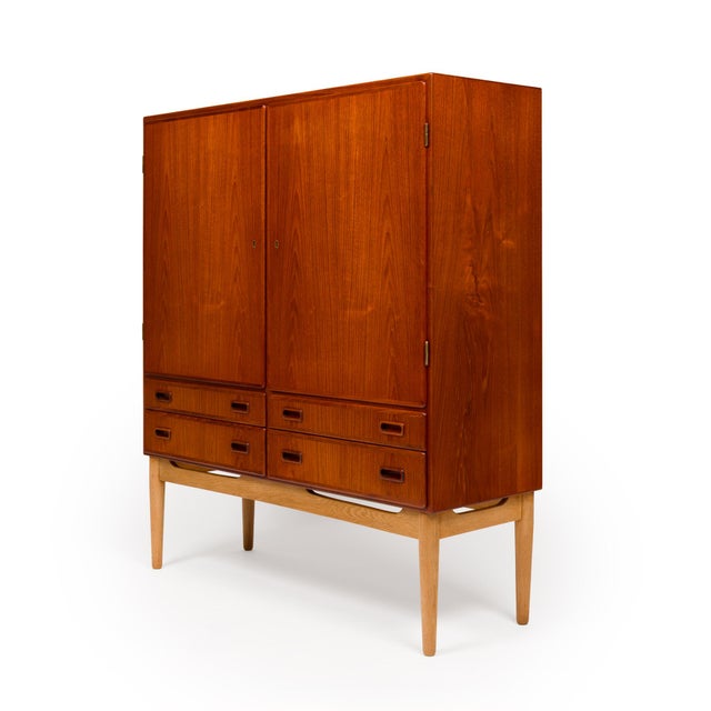 A standout example of Danish mid-century craftsmanship, this exceptional teak hutch/wardrobe showcases a beautifully...