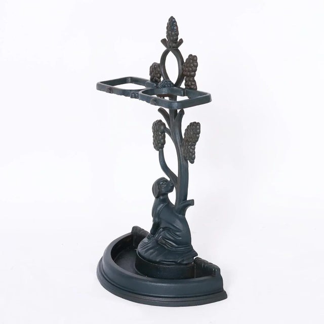 Charming antique English umbrella stand cast in iron with a top bracket supported by a stylized tree over a hunting dog...