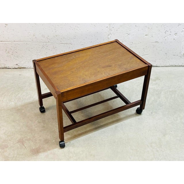 Vintage 1960s wood rolling utility cart with additional shelf for storage. The cart is strong and sturdy with castors that...